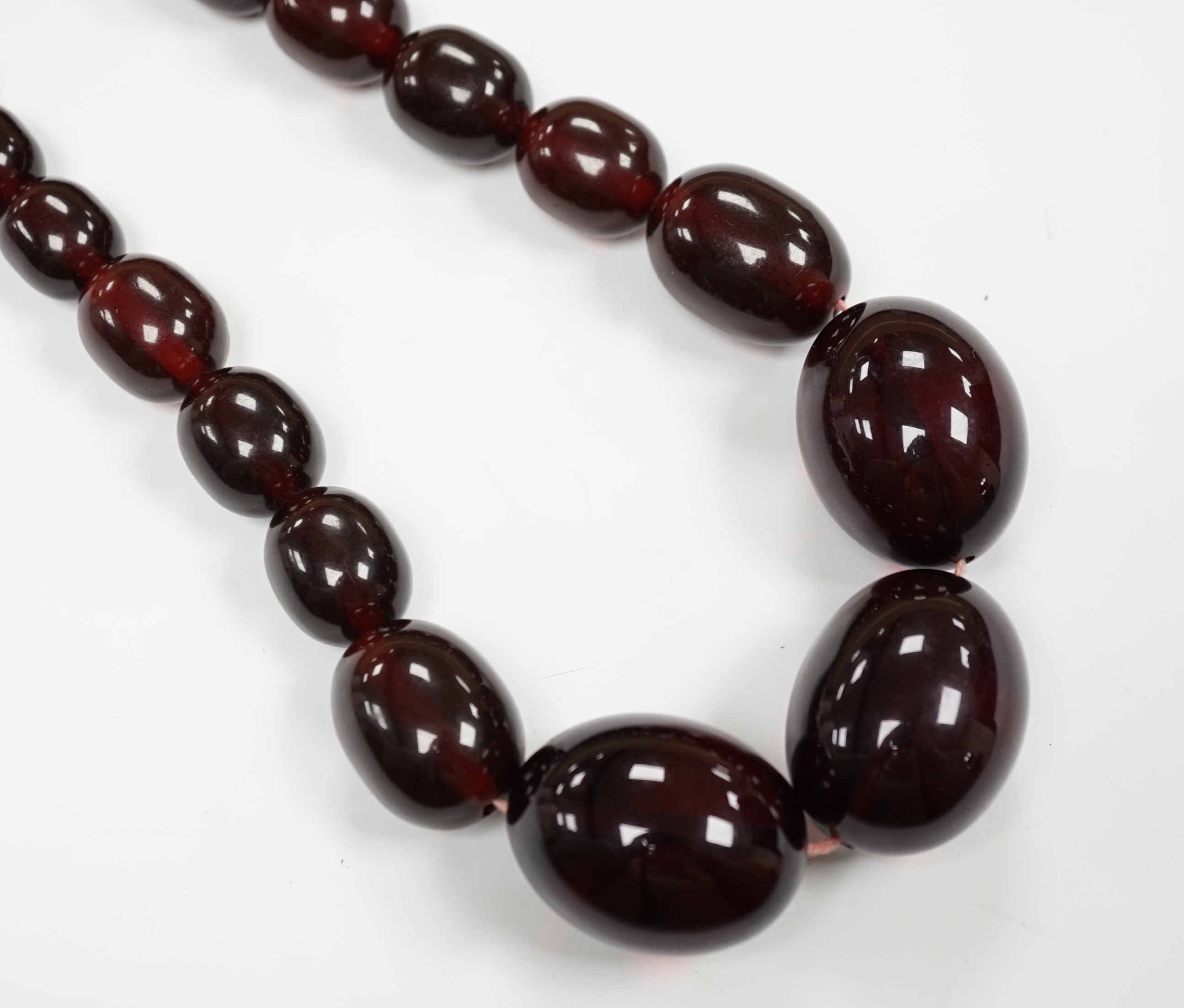 A single strand graduated simulated cherry amber bead necklace, 68cm, gross weight 151 grams.